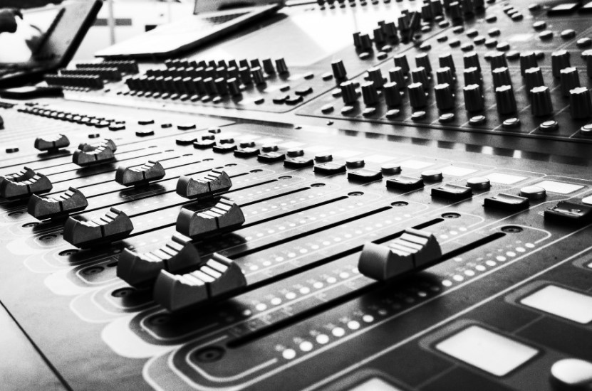 mixing desk sliders and dials on an audio mixer
